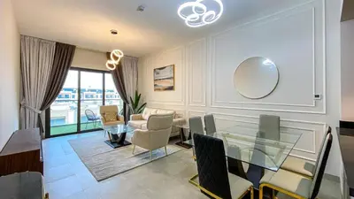 a living room with a glass table and a couch at 1BR Study luxury Furnished Utilities Included DXB in Dubai