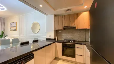 a kitchen with white cabinets and a counter top at 1BR Study luxury Furnished Utilities Included DXB in Dubai