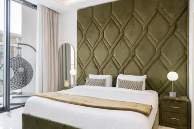 a bedroom with a large bed and a large wall at Vogue Dubai Hills The Pinnacle near Dubai Hills Mall and Park, One Bedroom Apartment with Large Balcony and City View, Access to all Amenities in Dubai