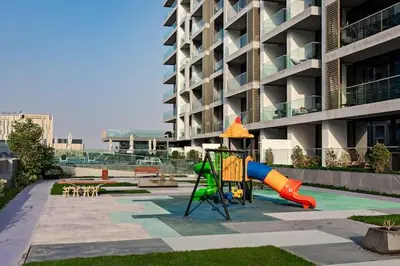a playground in front of a apartment building at Vogue Dubai Hills The Pinnacle near Dubai Hills Mall and Park, One Bedroom Apartment with Large Balcony and City View, Access to all Amenities in Dubai