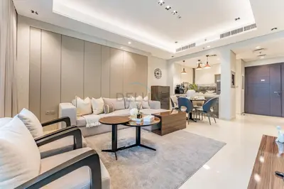 a living room with a couch and a table at Sky-High 2BR with City Views, Minutes Drive to Downtown, Steps from the Bus Stop, Nobles Tower, Business Bay by Deluxe Holiday Homes in Dubai