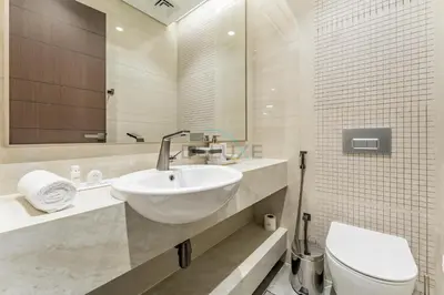 a bathroom with a sink and a toilet at Sky-High 2BR with City Views, Minutes Drive to Downtown, Steps from the Bus Stop, Nobles Tower, Business Bay by Deluxe Holiday Homes in Dubai