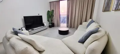 a living room with a couch and a tv at Grande-5703,2 BHK Down Town, Dubai in Dubai