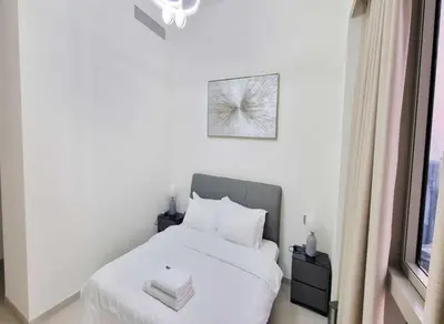 a bedroom with a white bed and a window at Grande-5703,2 BHK Down Town, Dubai in Dubai
