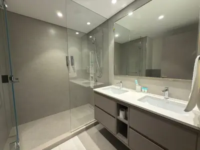 a bathroom with a glass shower and a sink at Grande-5703,2 BHK Down Town, Dubai in Dubai