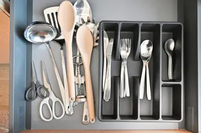 a utensil drawer with silver utensils in it at Aura by Grovy Studio - Parking, Sauna&Gym, Pool - by Rentujemy in Dubai