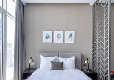 a bedroom with a bed with three pictures on the wall at Premium Living with Canal views and Top Notch Amenities in Dubai