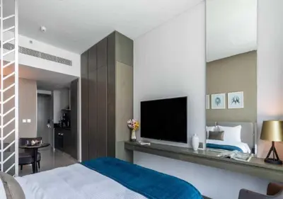 a bedroom with a bed and a flat screen tv at Premium Living with Canal views and Top Notch Amenities in Dubai