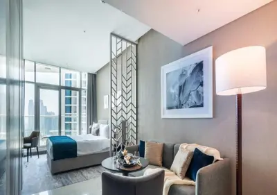 a living room with a couch and a bed at Premium Living with Canal views and Top Notch Amenities in Dubai
