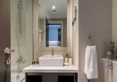a bathroom with a white sink and a mirror at Premium Living with Canal views and Top Notch Amenities in Dubai