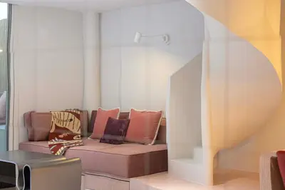 a living room with a couch with pillows on it at Stylish Studio Loft with Outdoor Patio in JVC in Dubai