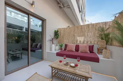 a patio with a couch and a table at Stylish Studio Loft with Outdoor Patio in JVC in Dubai