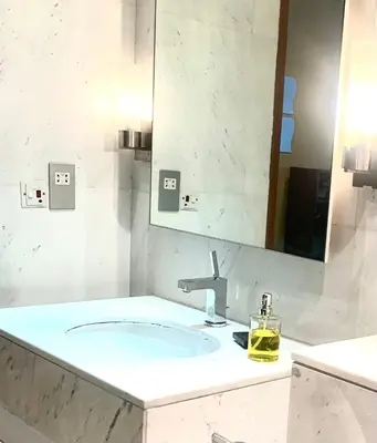 a bathroom with a sink and a mirror at Kempinski Central Avenue Residence Largest 1BR with Burj Khalifa View in Dubai