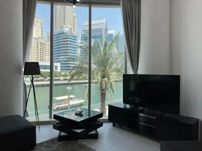 a living room with a large window with a view at Modern 2 Bedroom Apartment in Dubai Marina in Dubai