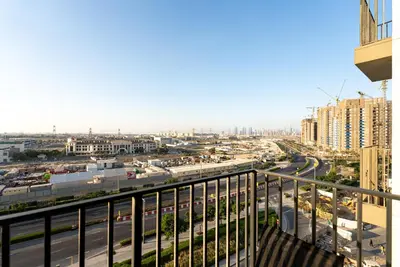 a view of a city from a balcony at Escape24 Contemporary 1BR with City Views in Dubai Hills in Dubai