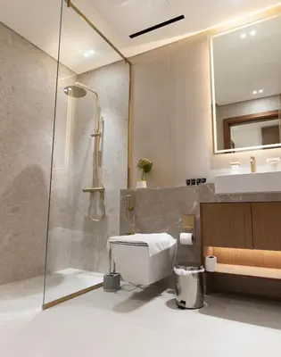 a bathroom with a shower and a toilet and a sink at Luxury Studio - Private Jacuzzi & Burj Khalifa View in Dubai