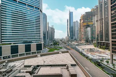 a view of a city with tall buildings at Brand New Building! 2 Double Bed! Ideal Location with 5-star Pool and Gym! in Dubai