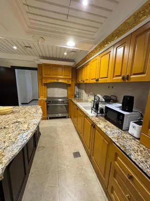 a large kitchen with wooden cabinets and granite counter tops at Smile Home Marina JBR Bed space in Dubai