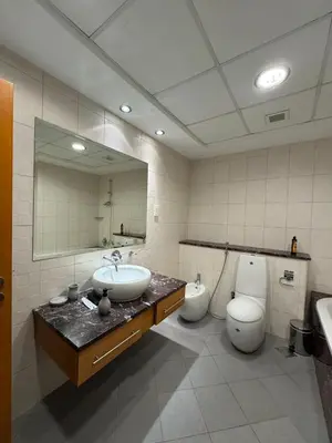 a bathroom with a sink and a toilet and a mirror at Smile Home Marina JBR Bed space in Dubai
