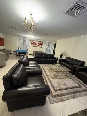 a living room with black leather couches and a table at Smile Home Marina JBR Bed space in Dubai