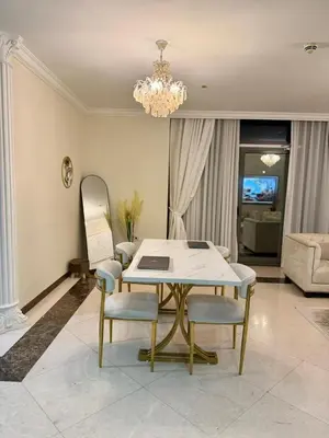 a living room with a table and chairs and a chandelier at Smile Home Marina JBR Bed space in Dubai