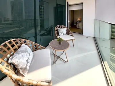 a balcony with a table and chairs on a building at SOLARTE Luxe - LIV Marina - Premium 2BR Residence in Dubai