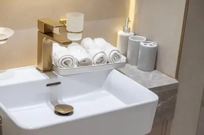 a bathroom with a white sink with towels at Elegant 2BR With Modern Design Near to Circle Mall in Dubai