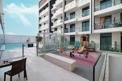 an apartment patio with a playground on the side of a building at Elegant 2BR With Modern Design Near to Circle Mall in Dubai
