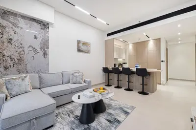 a living room with a couch and a table at Elegant 2BR With Modern Design Near to Circle Mall in Dubai