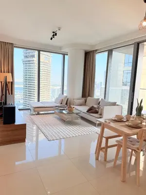 a living room with a couch and a table at Dubai Mall connected, 38th floor, Amazing pool in Dubai