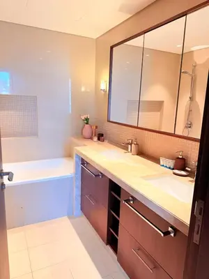 a bathroom with a tub and a sink and a mirror at Dubai Mall connected, 38th floor, Amazing pool in Dubai