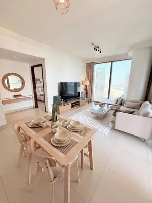 a living room with a table and a couch at Dubai Mall connected, 38th floor, Amazing pool in Dubai