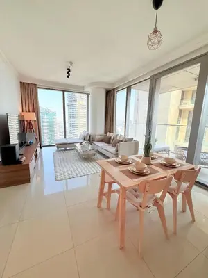 a living room with a table and chairs and a couch at Dubai Mall connected, 38th floor, Amazing pool in Dubai