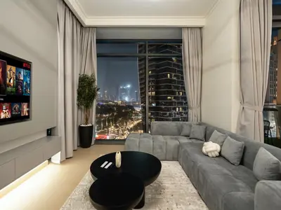 a living room with a couch and a table at Stunning 4BR Burj View Pool &Gym in Dubai