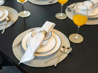 a black table with plates and glasses of orange juice at Stunning 4BR Burj View Pool &Gym in Dubai