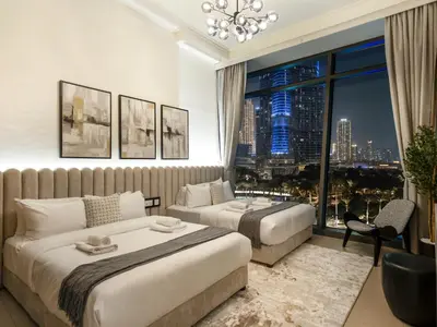 a hotel room with two beds and a large window at Stunning 4BR Burj View Pool &Gym in Dubai