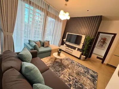 a living room with a couch and a tv at Free Infiniti Pool and Jacuzzi - Marina Gate Luxury Stay - Enjoy Dubai Marina Views in Dubai