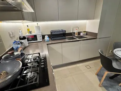 a kitchen with a stove top oven next to a sink at Free Infiniti Pool and Jacuzzi - Marina Gate Luxury Stay - Enjoy Dubai Marina Views in Dubai