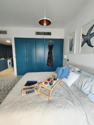 a bedroom with a large bed with a table on it at Stylish JLT Apartment - Marina Skyline View - Next to Metro - Walk to Beach in Dubai