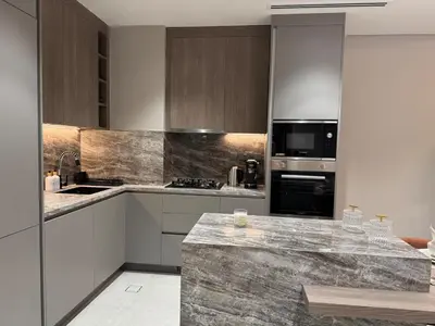 a kitchen with stainless steel appliances and a marble counter top at Dubai corner at Westwood Imtiaz 1BR apartment in Dubai