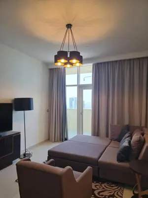 a living room with a couch and a large window at شقة بالجي في سي Spacious apartment in Damac Ghalia JVC, Dubai in Dubai