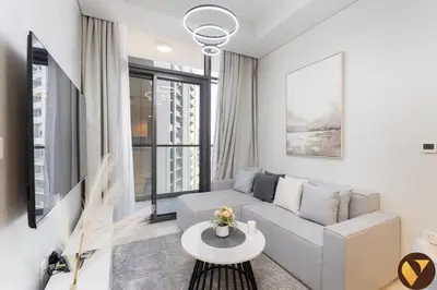 a living room with a couch and a table at Vogue Business Bay Aykon City Close to Downtown Burj Khalifa and Dubai Mall Burj Khalifa and Dubai Mall, One Bedroom Apartment with Balcony and City View, Access to all Amenities in Dubai