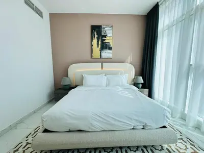 a bedroom with a large white bed with two windows at Peaceful 1BR - Near DIFC & Trade Center and Downtown in Dubai