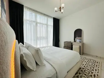 a bedroom with a bed and a large window at Peaceful 1BR - Near DIFC & Trade Center and Downtown in Dubai