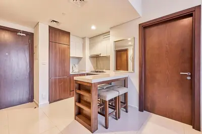 a kitchen with a counter and a wooden door at Modern 2BR Retreat Canal Views Near Downtown in Dubai