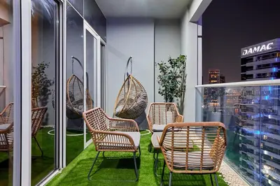 a group of chairs and a table on a balcony at Modern 2BR Retreat Canal Views Near Downtown in Dubai