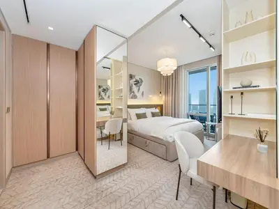 a bedroom with a bed and a desk and a table at 2 Bedroom Luxury Burj Khalifa & Fountain View Connected to Dubai Mall in Dubai