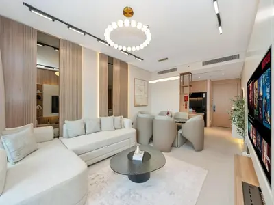 a living room with a white couch and a table at 2 Bedroom Luxury Burj Khalifa & Fountain View Connected to Dubai Mall in Dubai