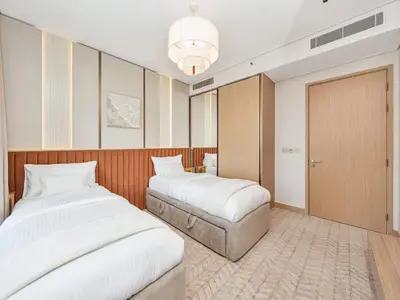 a hotel room with two beds and a closet at 2 Bedroom Luxury Burj Khalifa & Fountain View Connected to Dubai Mall in Dubai