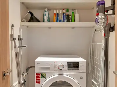 a laundry room with a washer and dryer at 2 Bedroom Luxury Burj Khalifa & Fountain View Connected to Dubai Mall in Dubai